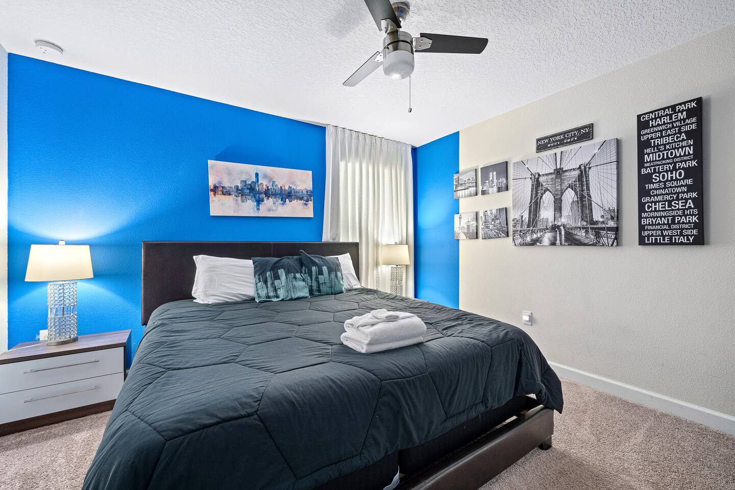Bedroom Oasis: Vibrant blue walls and chic decor create a perfect retreat for yo