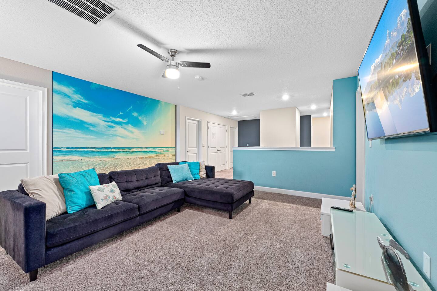 Living Room: Bright, beach-inspired decor and a comfy sectional await your relax