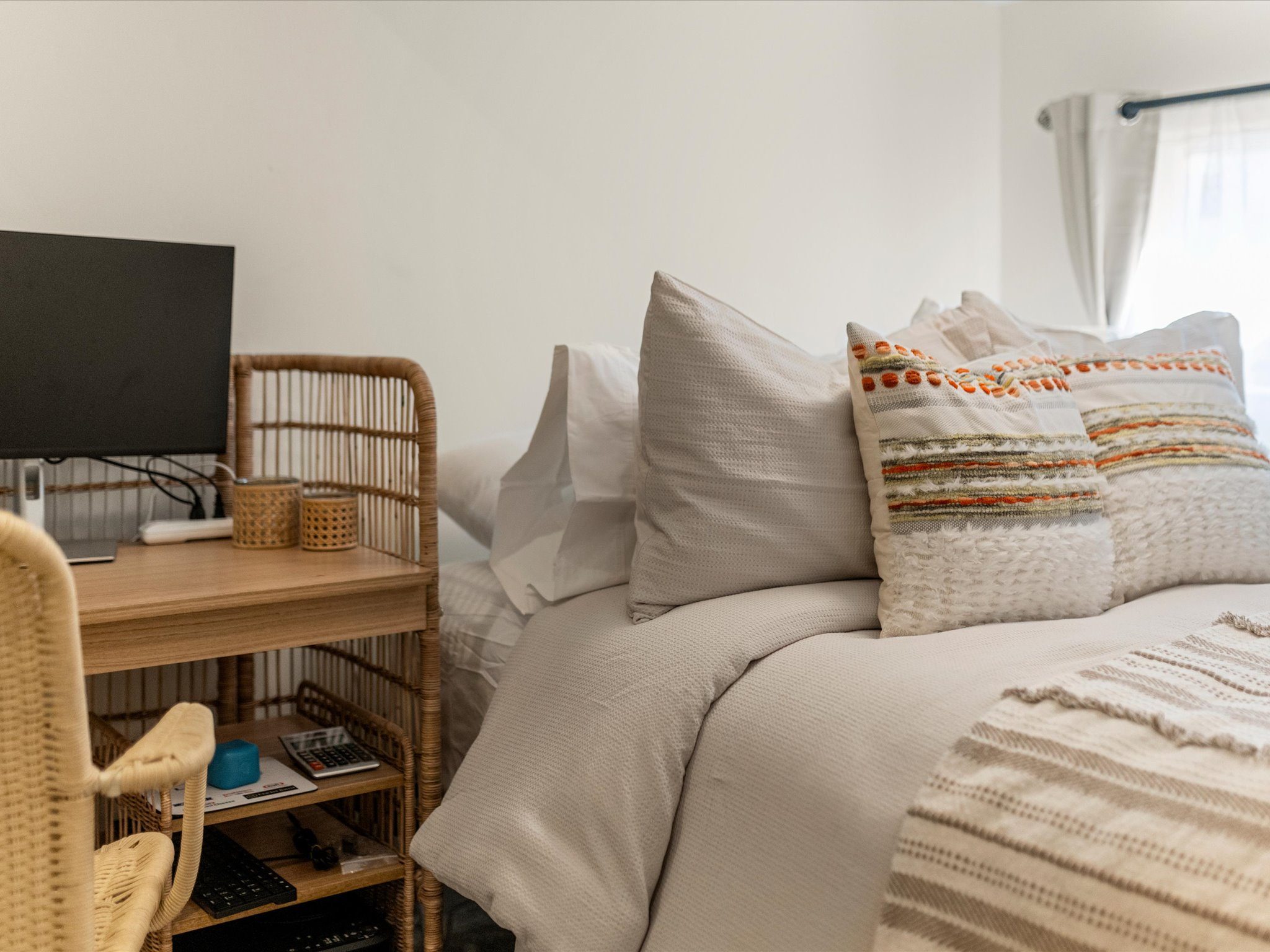 Cozy bedroom with plush bedding and workspace