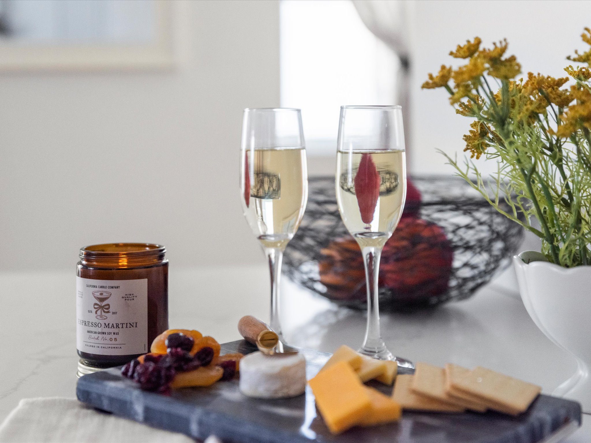 Champagne flutes and a charcuterie board on the kitchen counter
