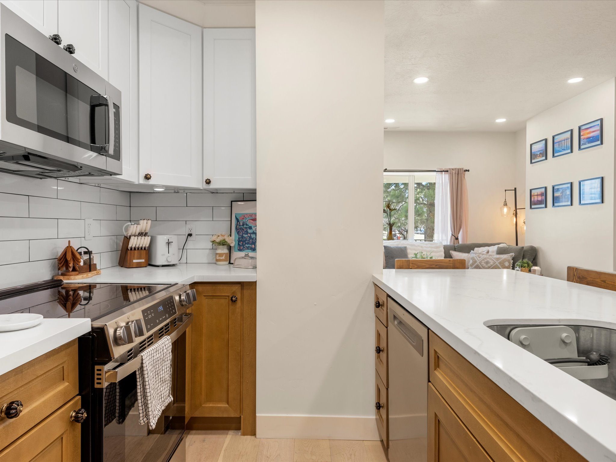 Kitchen with electric range, microwave, and Salt Lake City wall art