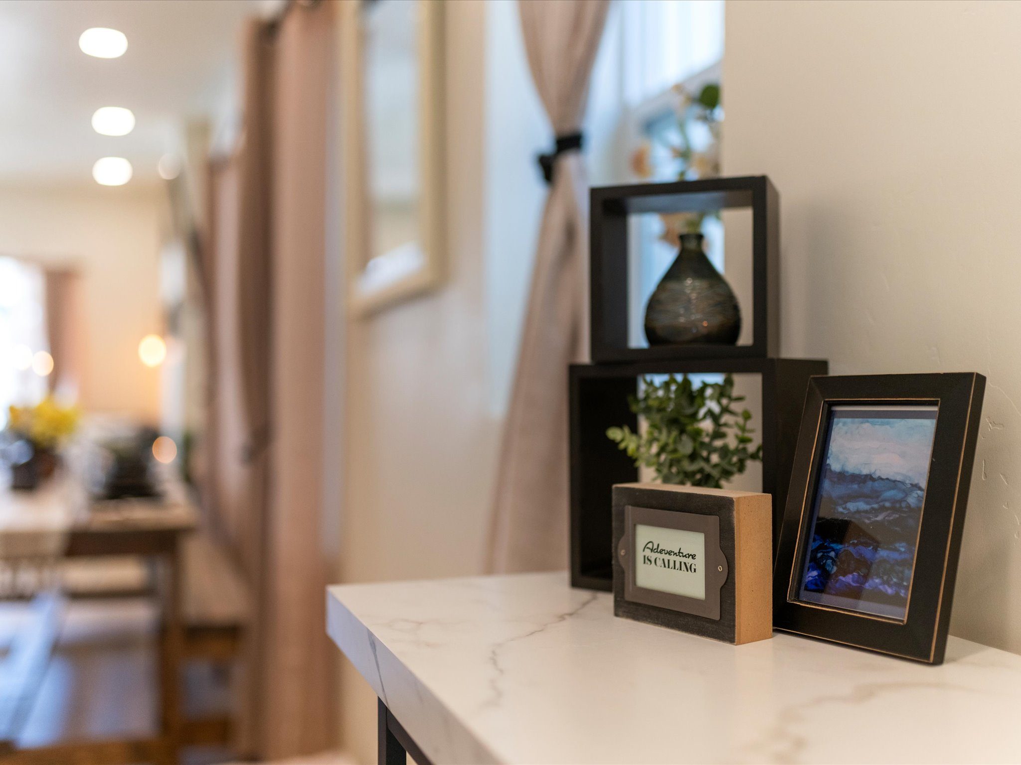 Entry console styled with framed art and decorative accents