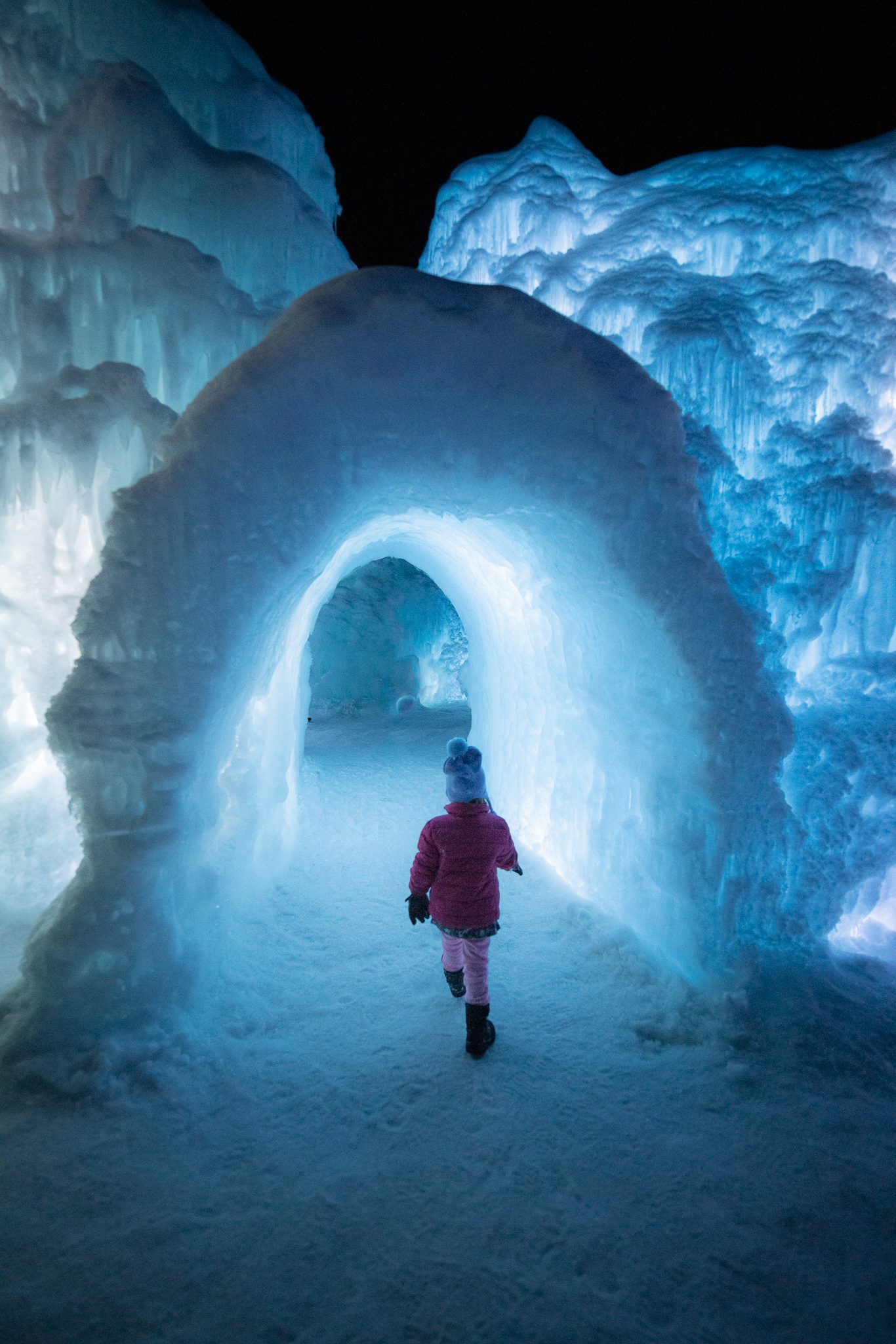 Winter ice castles attraction with lantern-lit ice tunnels