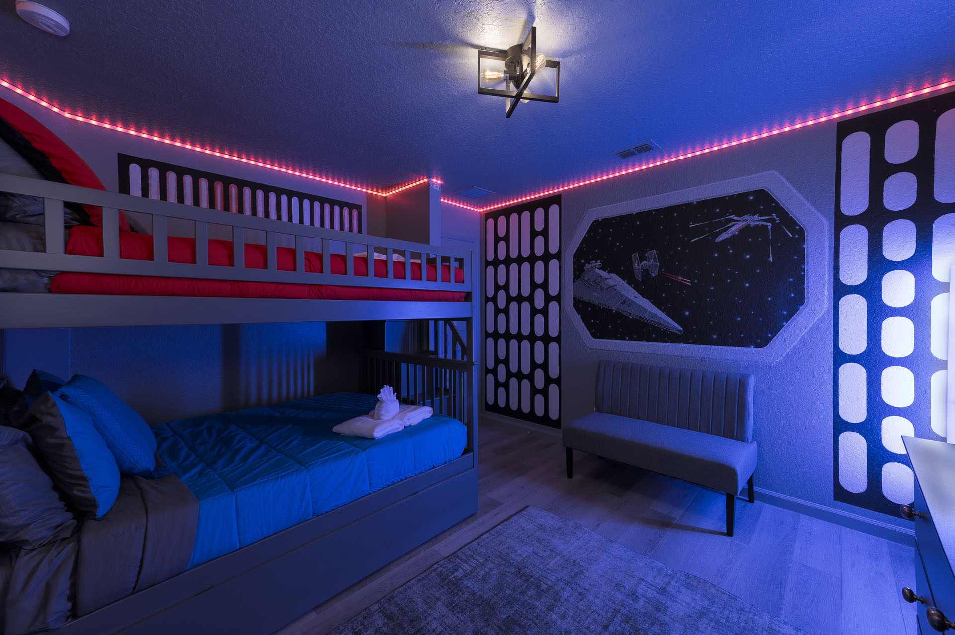 Star Wars bedroom with bunk beds plus a pull-out trundle and galactic wall mural