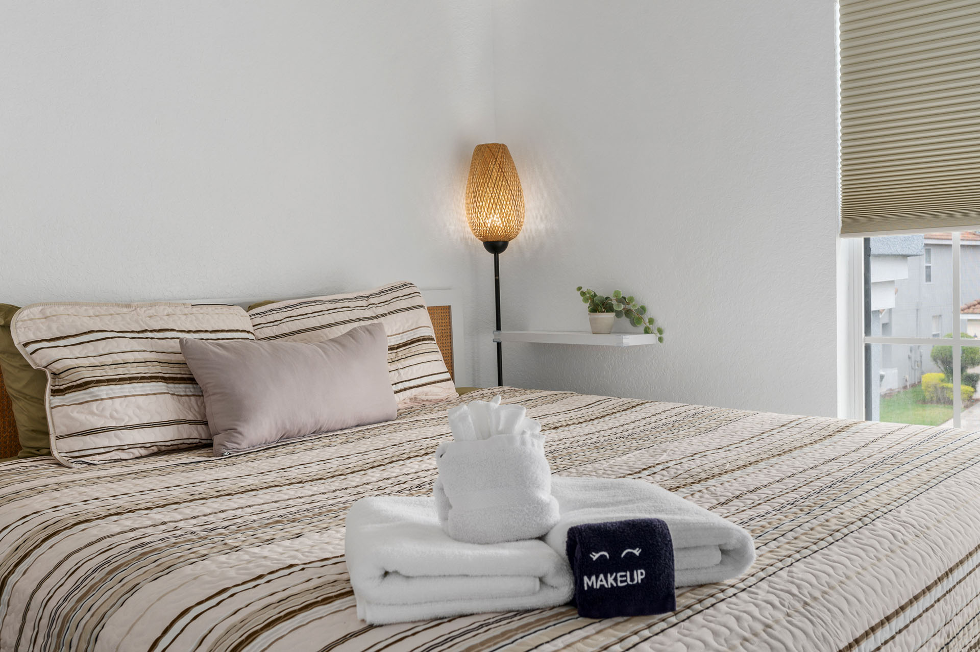 Soft neutral linens and warm lighting in the king bedroom.