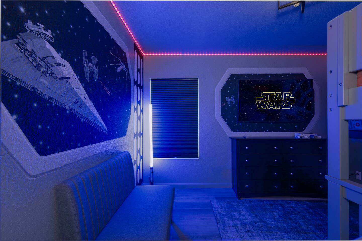 Starship-window mural and TV wall in the Star Wars bedroom.
