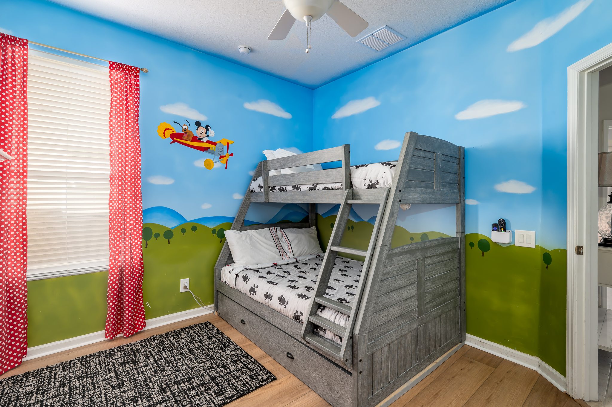 Playful kids’ room with mural + twin/full bunk & trundle