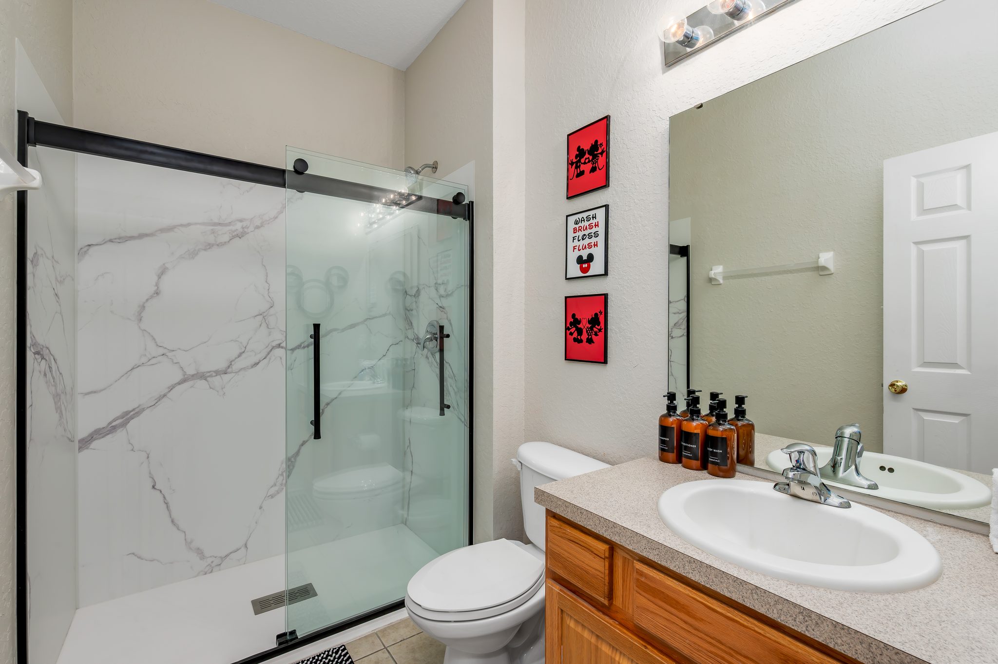 Modern bath shower, big mirror, and toiletries