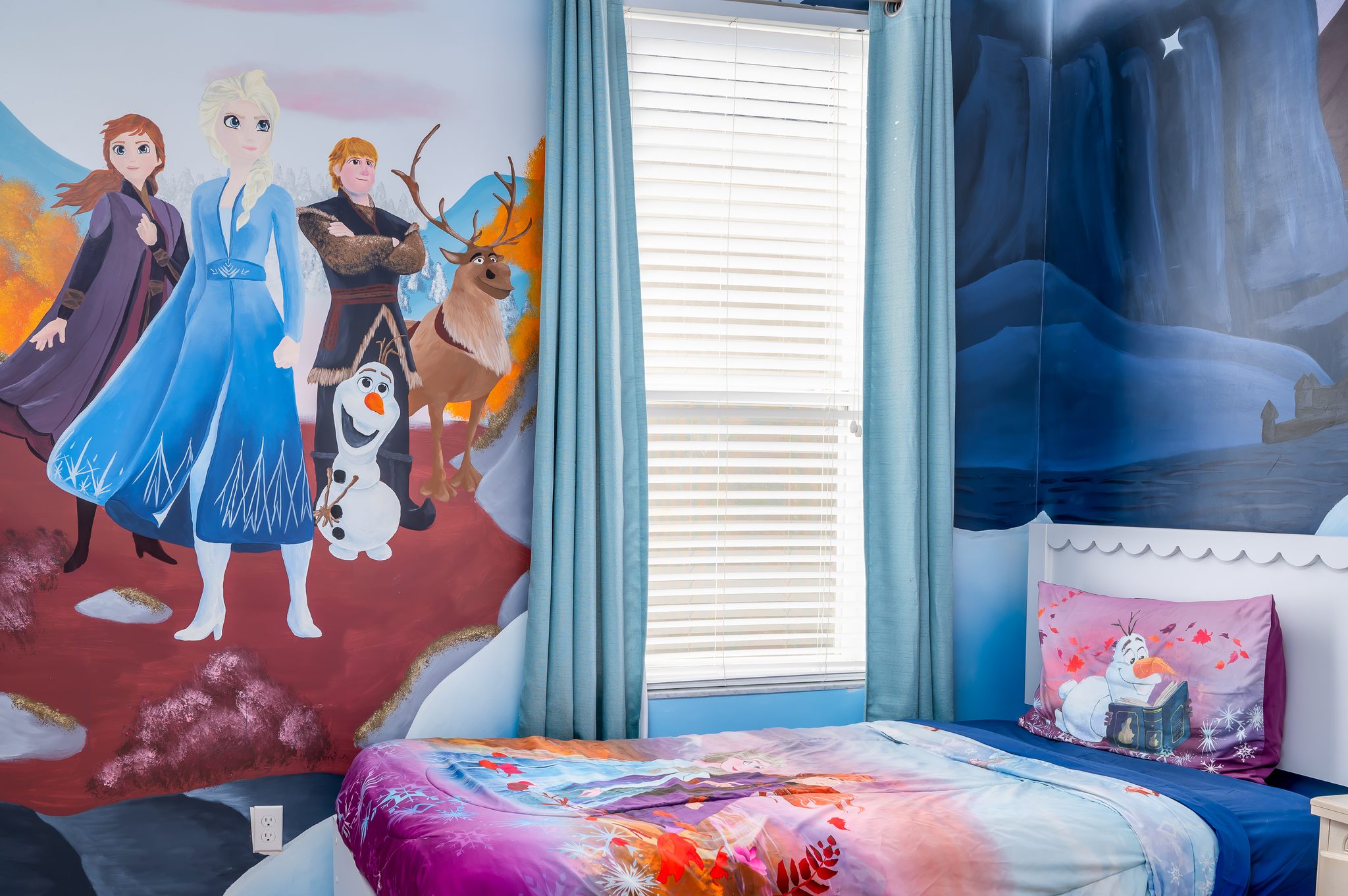 Whimsical Frozen-themed kids room with mural and cozy twin bed