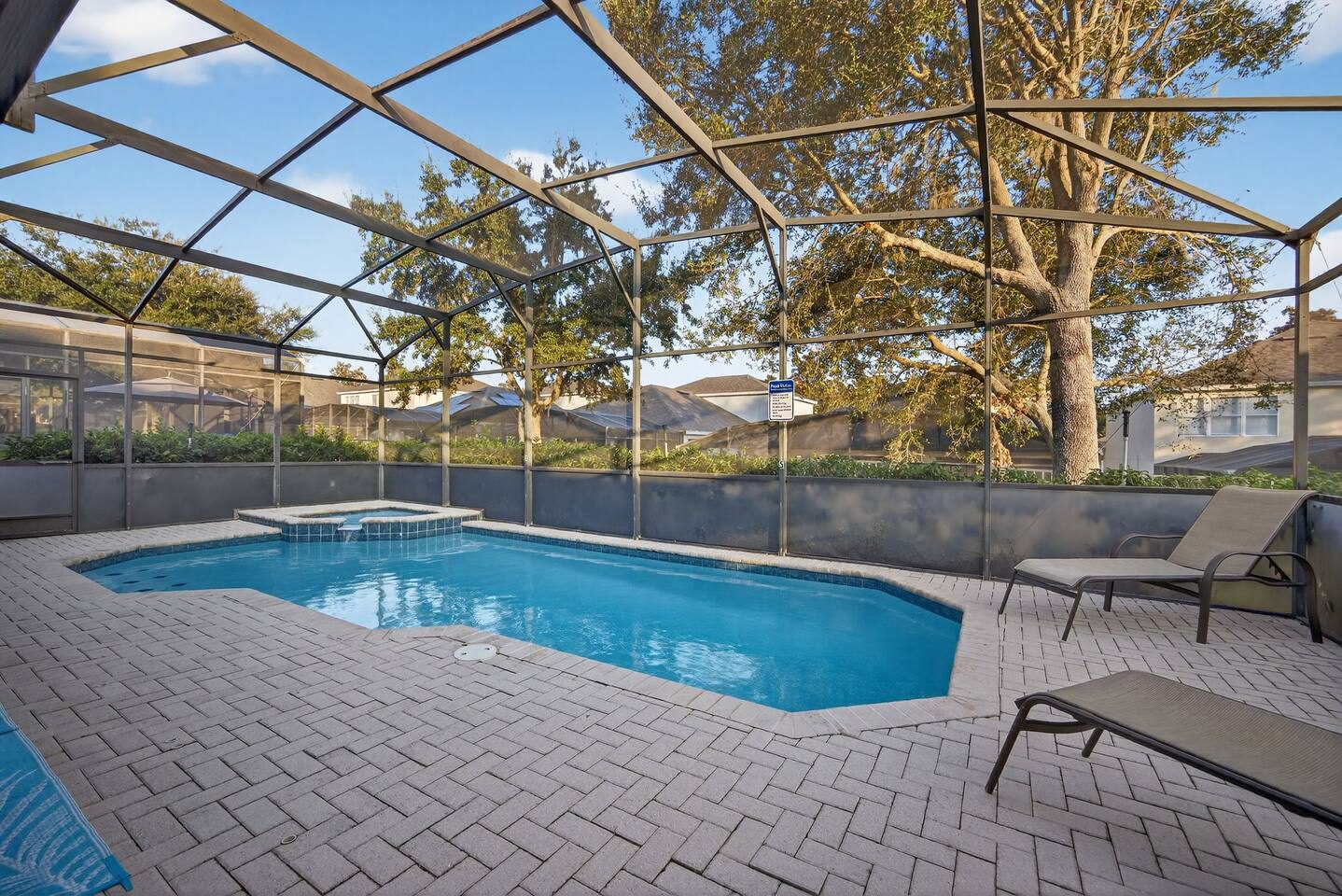 Golden-hour light over the private pool and brick-paver deck