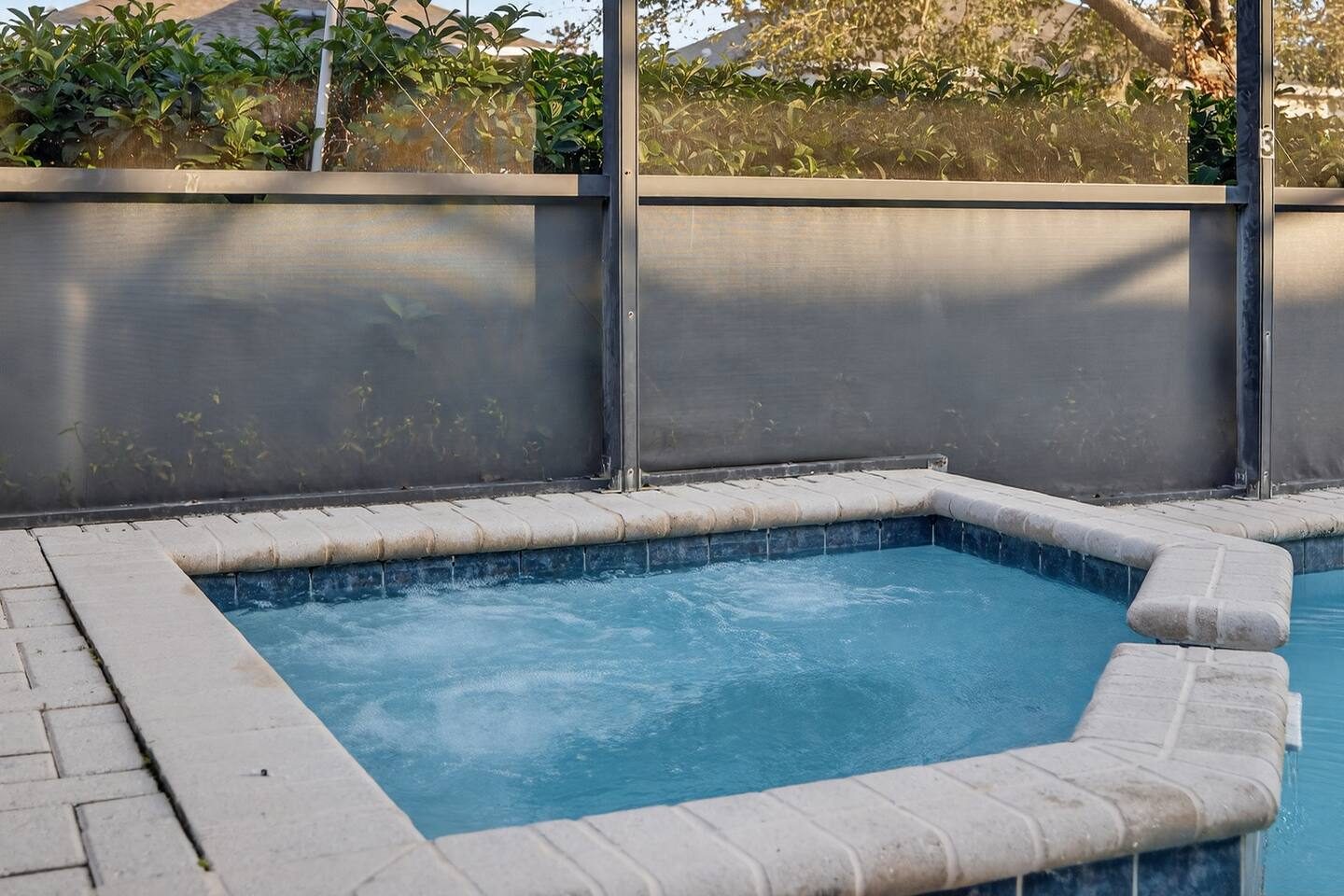 Jets on — the heated spa bubbling beside the pool