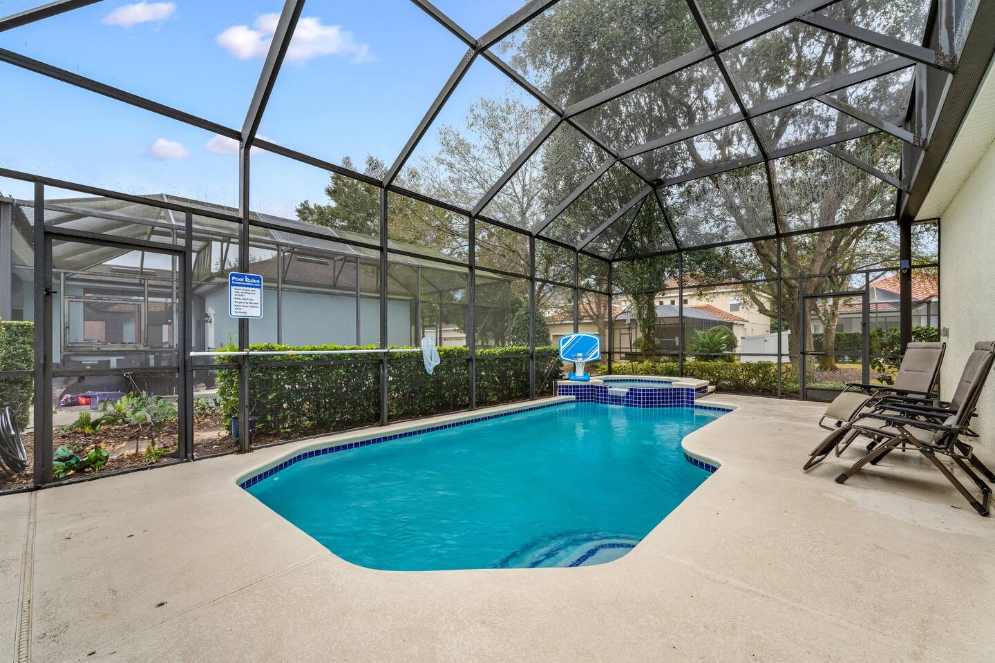 Refreshing pool retreat in screened enclosure, perfect for sun-soaked relaxation