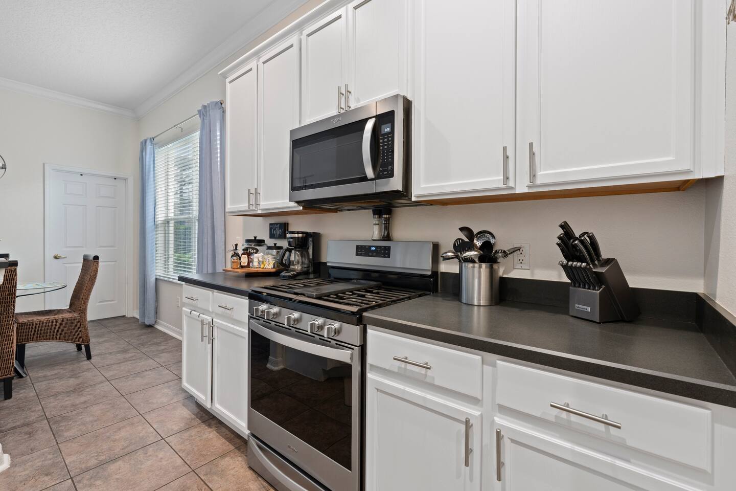 Whip up culinary delights in this modern setup with sleek appliances and invitin