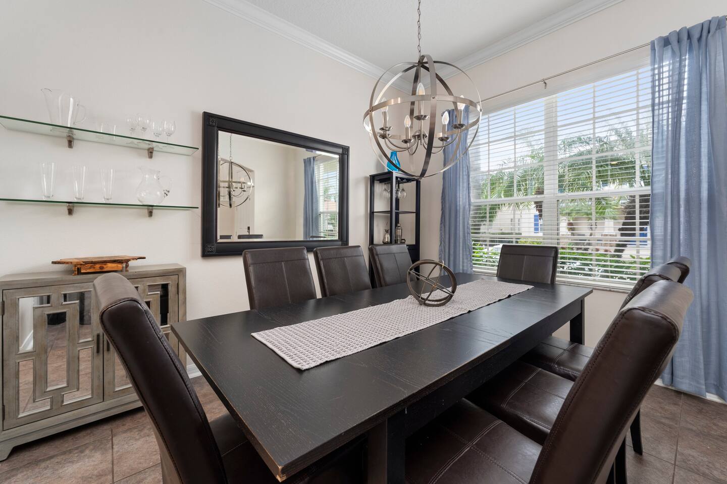 Dine in style under a chic chandelier, with views of lush palm trees!