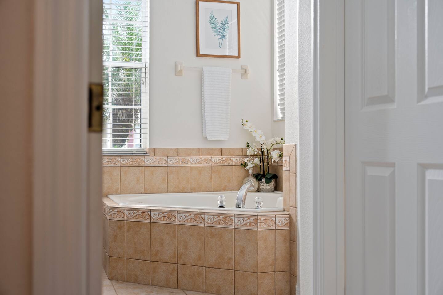 Indulge in luxury with a spacious tub and serene tropical views!