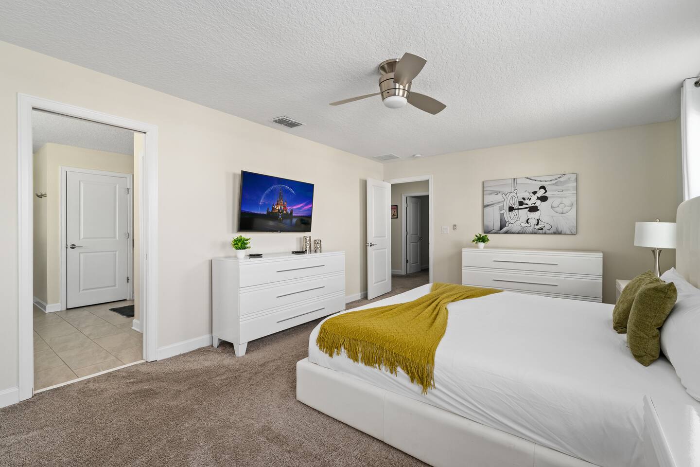 Master suite dressers with Steamboat Willie canvas art and en suite entry