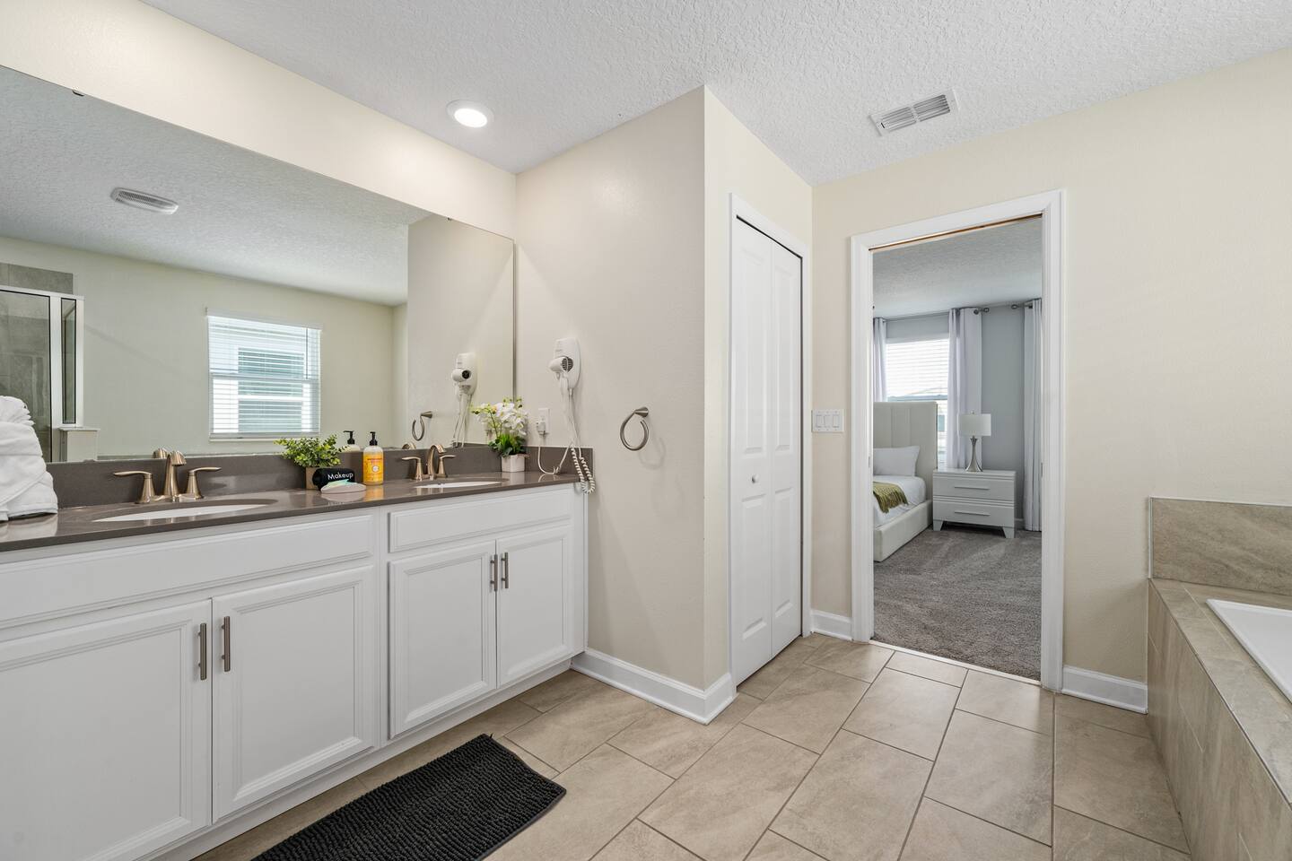Master bathroom double vanity with view into the bedroom