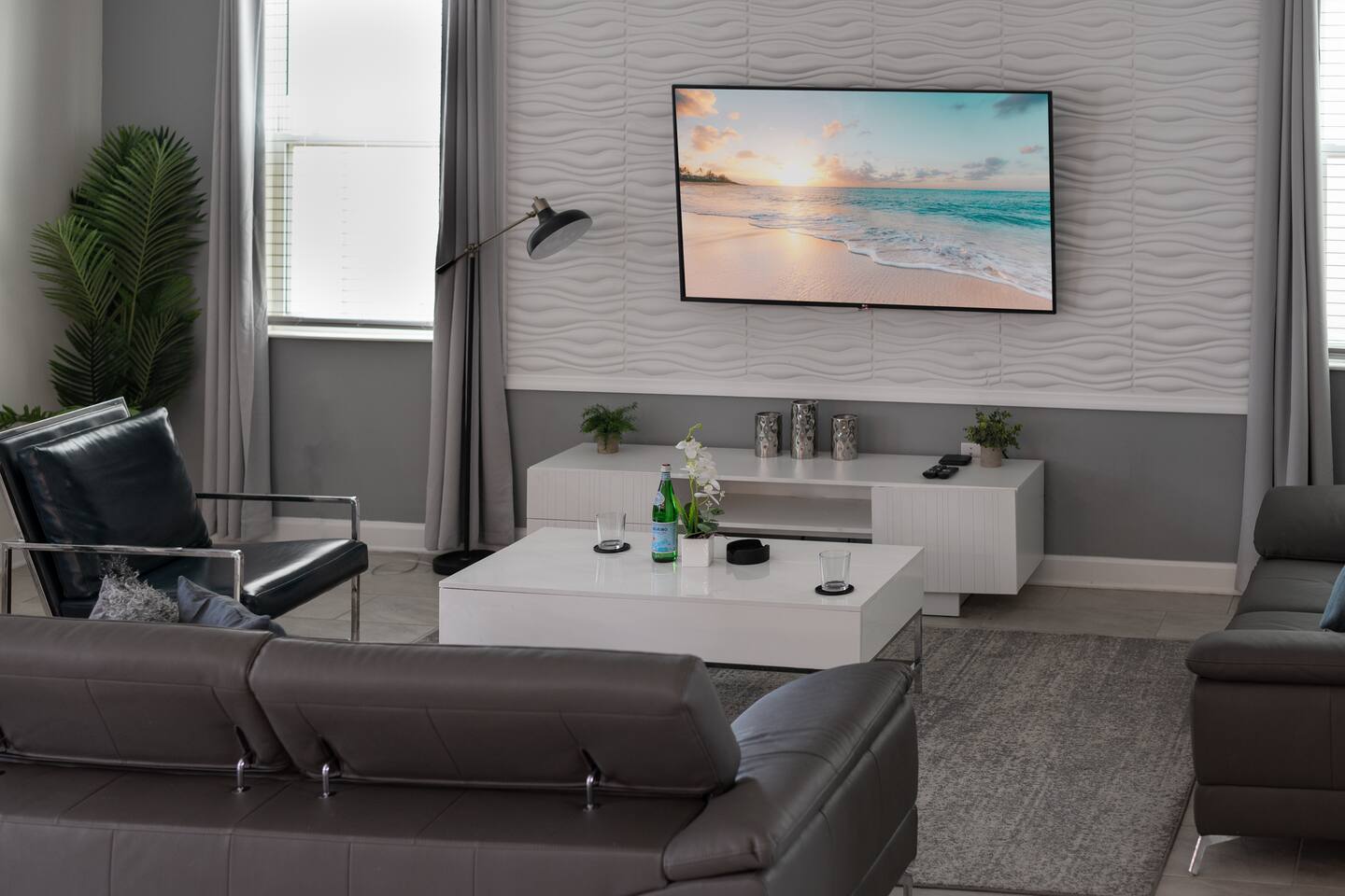 Living room media wall with wall-mounted TV and white console
