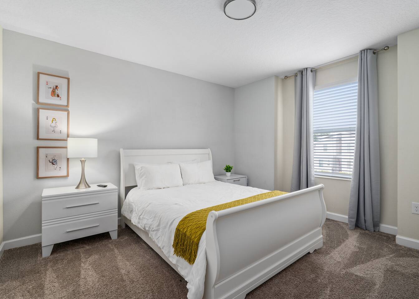 Peter Pan king room with long dresser, wall-mounted TV, and pixie-dust plaque