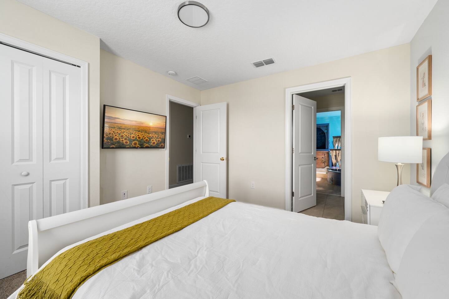 Queen sleigh bed with hallway view toward the themed kids' rooms