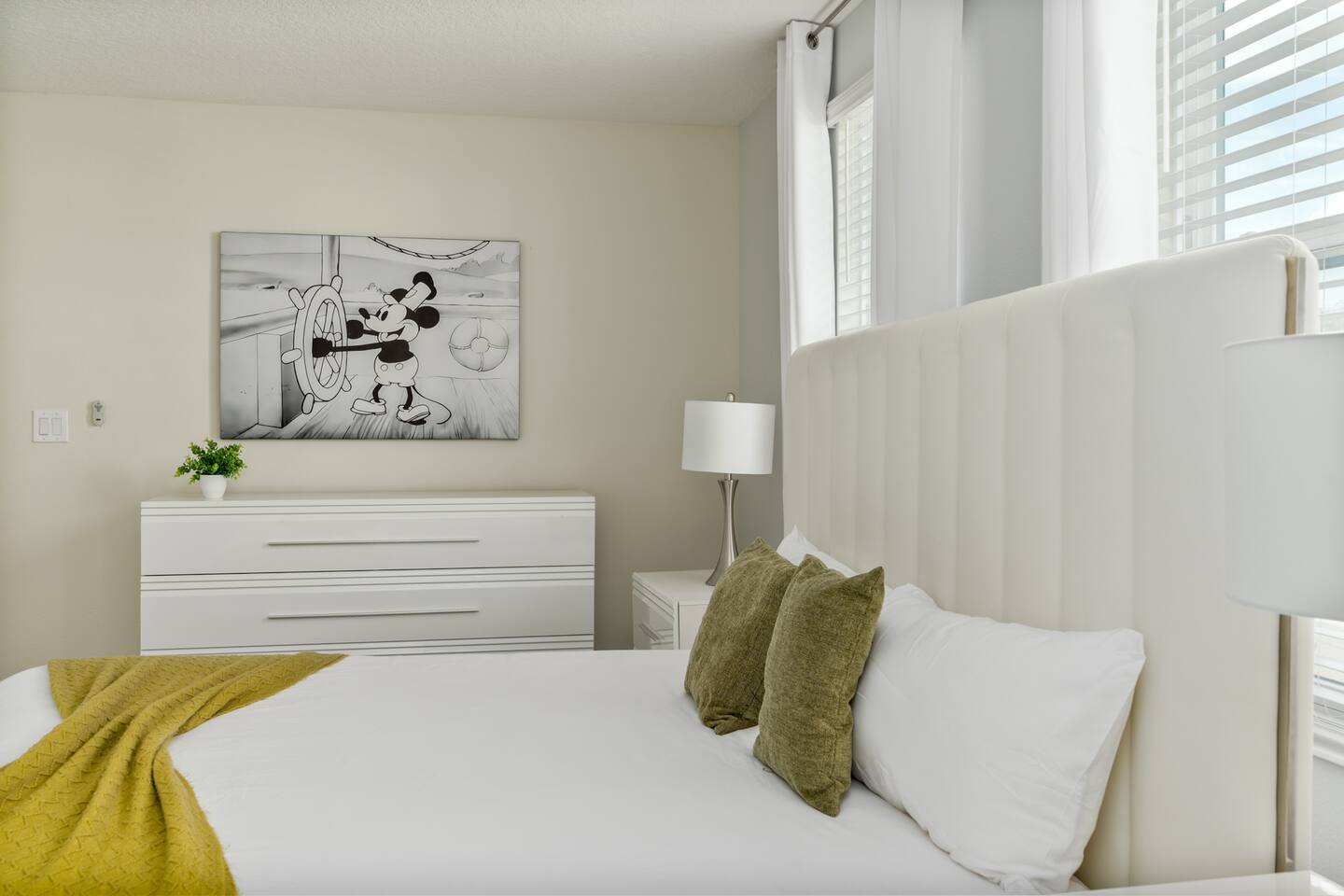 King bed and Steamboat Willie canvas art in the Mickey master suite