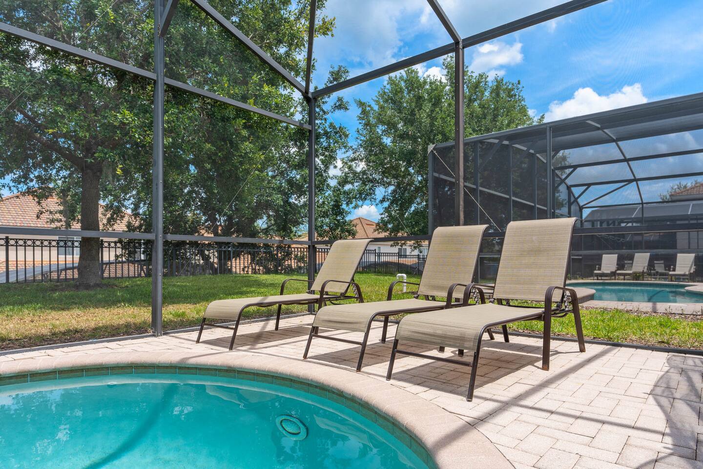 Soak in the sun by the pool with lounge chairs and lush green views!