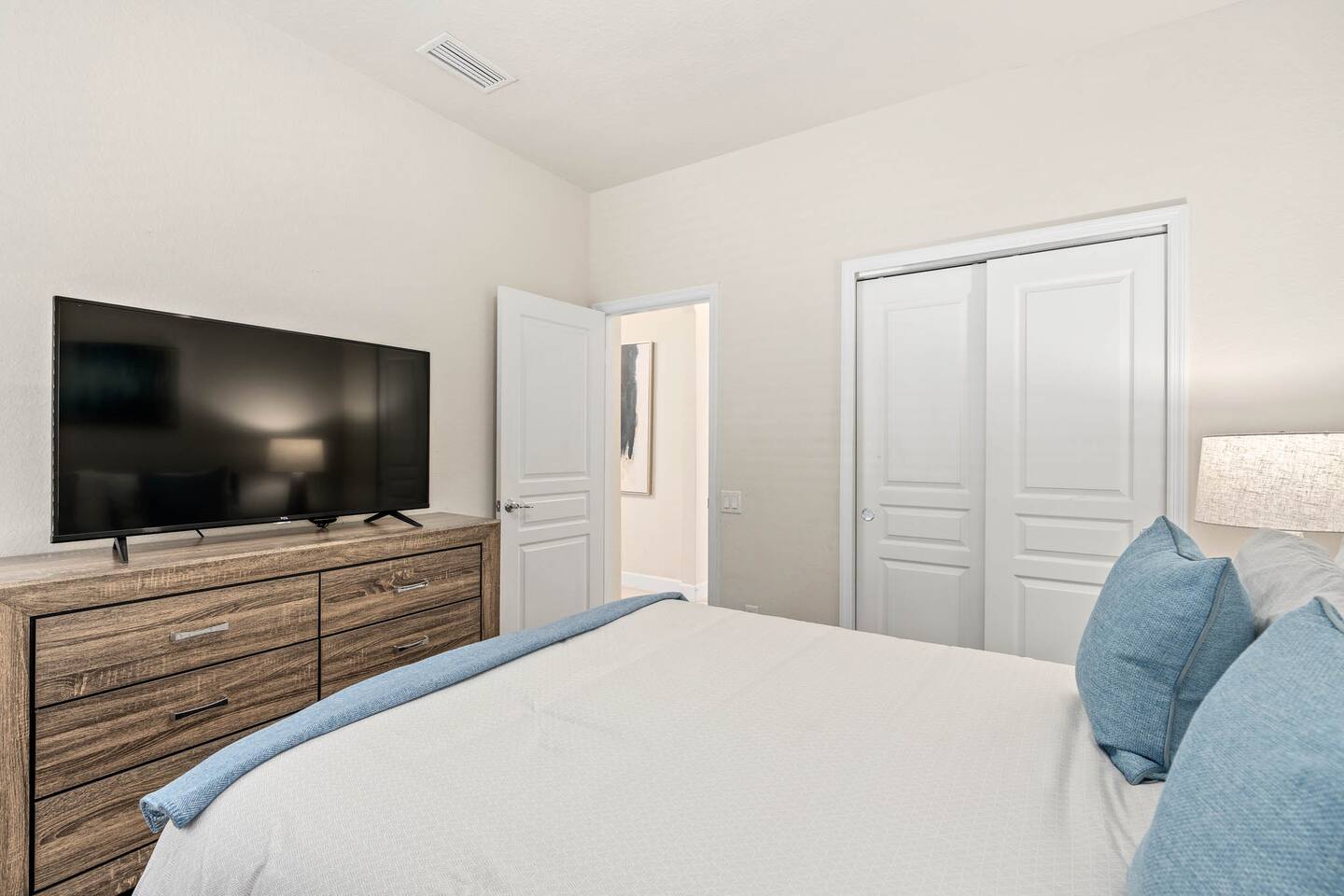 Plush bed, sleek TV, and calming decor! Perfect for unwinding!