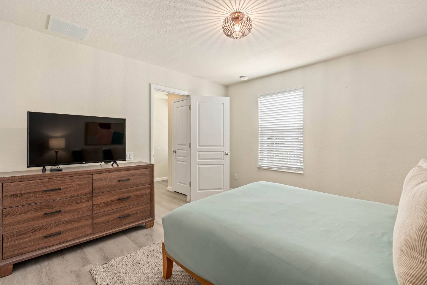 Chic bed, modern decor, and natural light!
