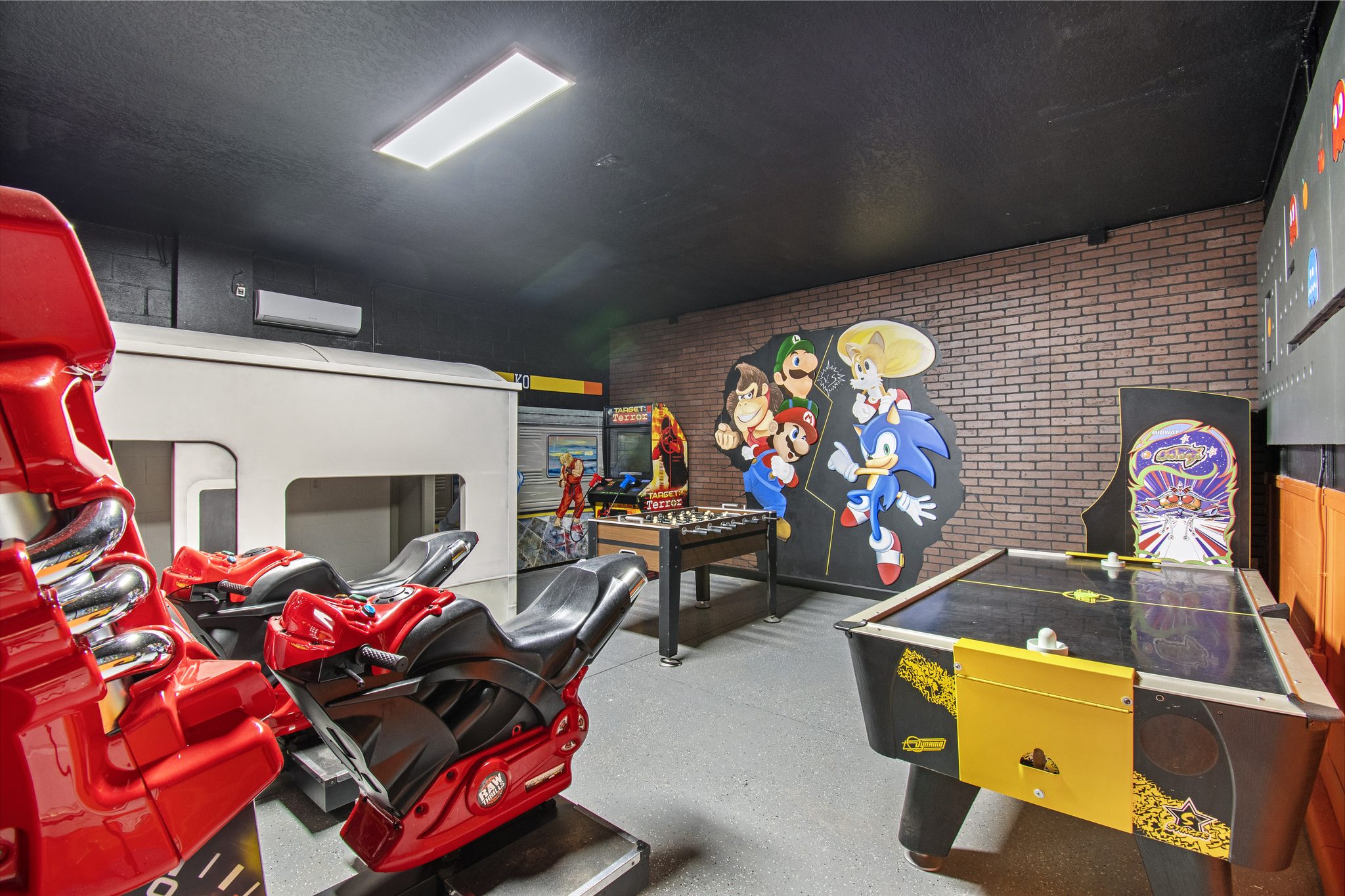 Game room with motorcycle racing arcades, air hockey, foosball, and video-game c