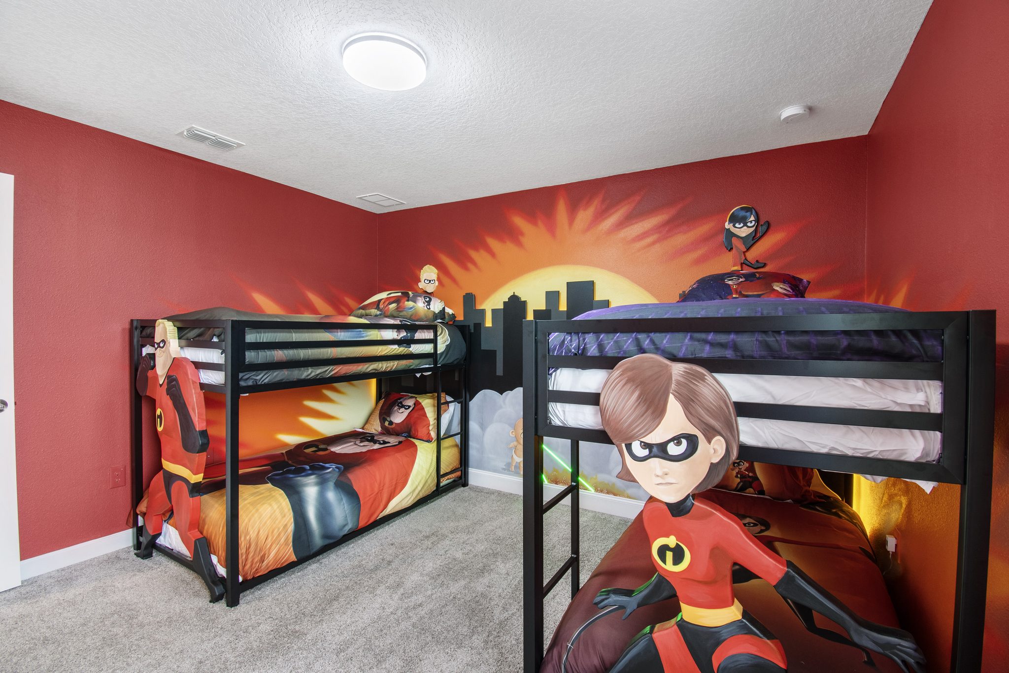 The Incredibles-themed bedroom with character murals and twin-over-twin bunks