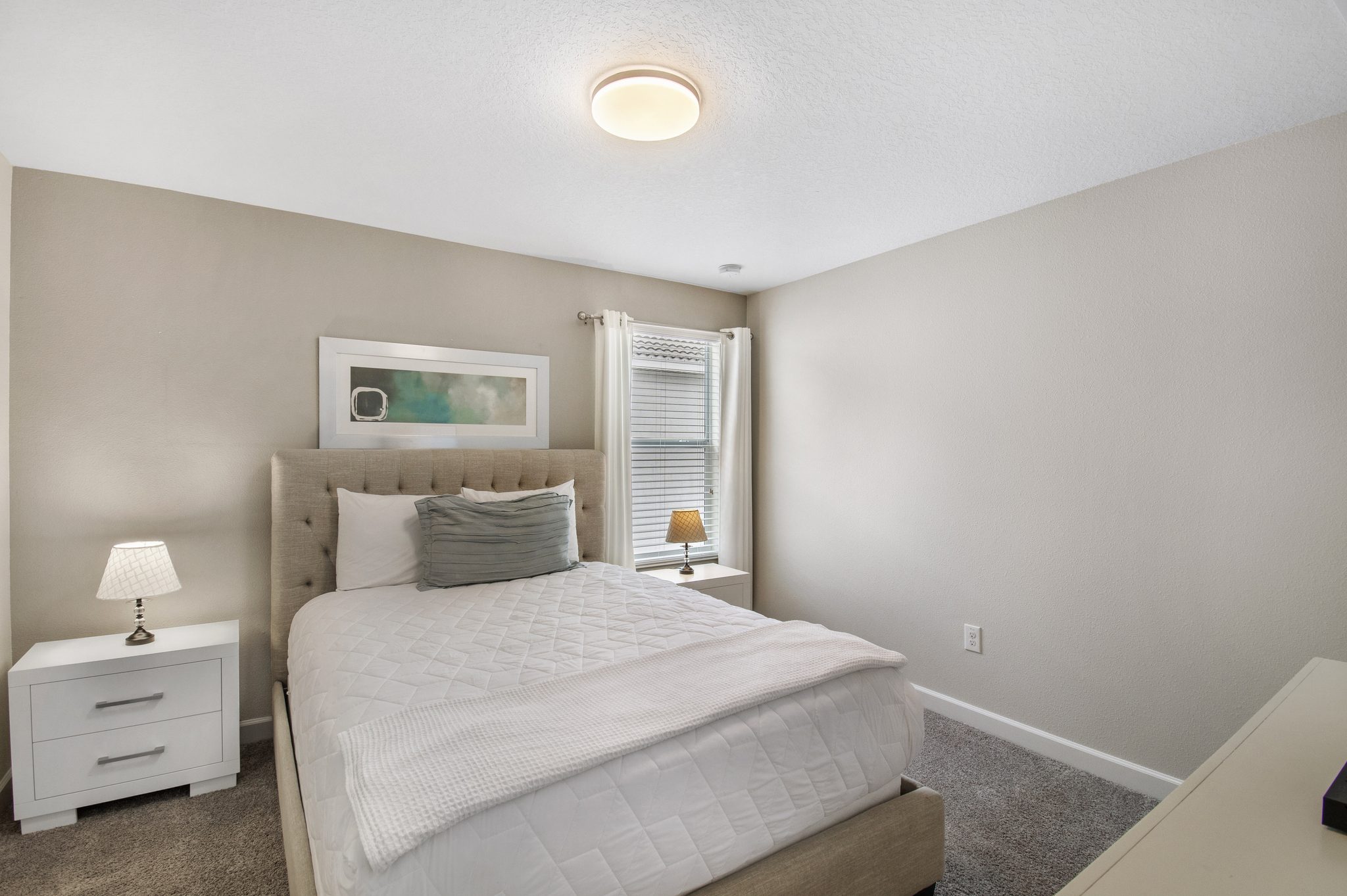 Bedroom with a queen bed, closet, and en-suite bathroom access