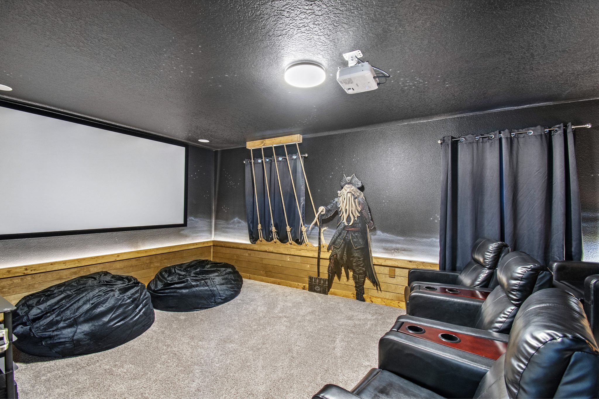 Pirates of the Caribbean-themed theater with projector screen and bean bag seati