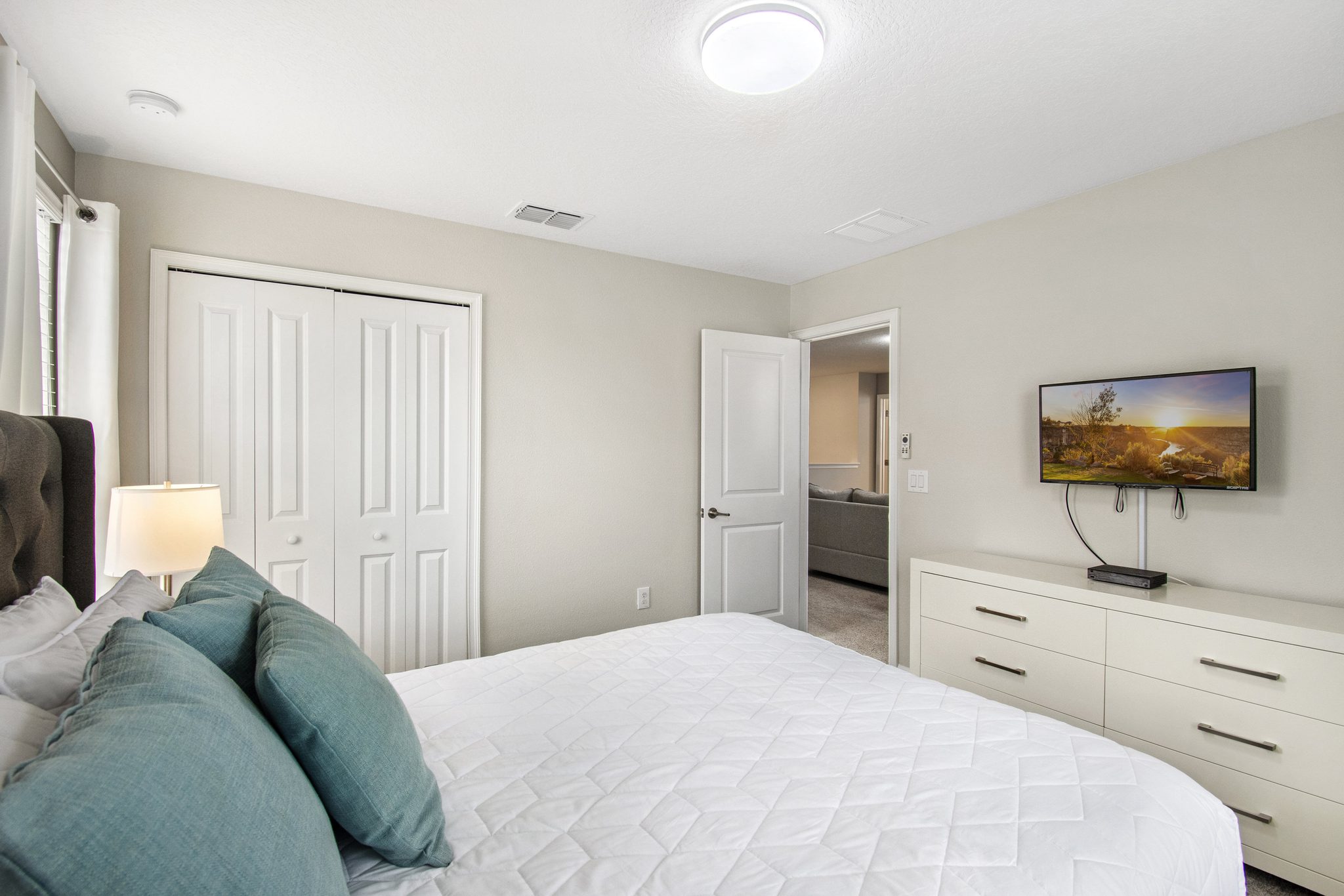 Bedroom with a queen bed, closet, and doorway to the upstairs loft