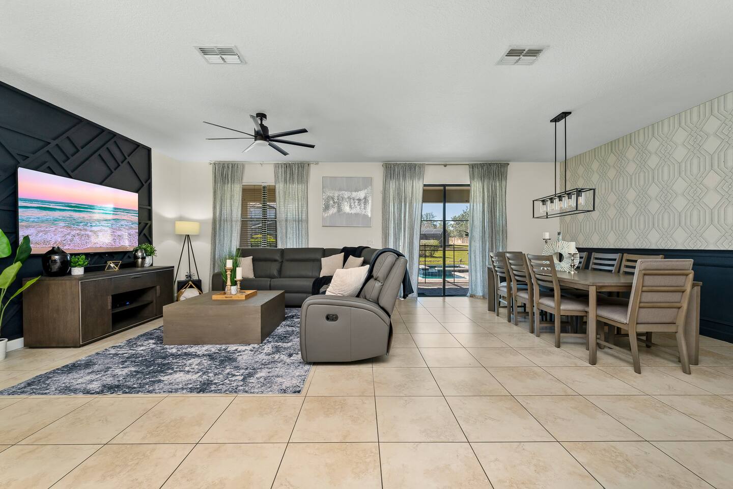 Stylish space with plush seating, modern decor, and serene pool views—perfect fo