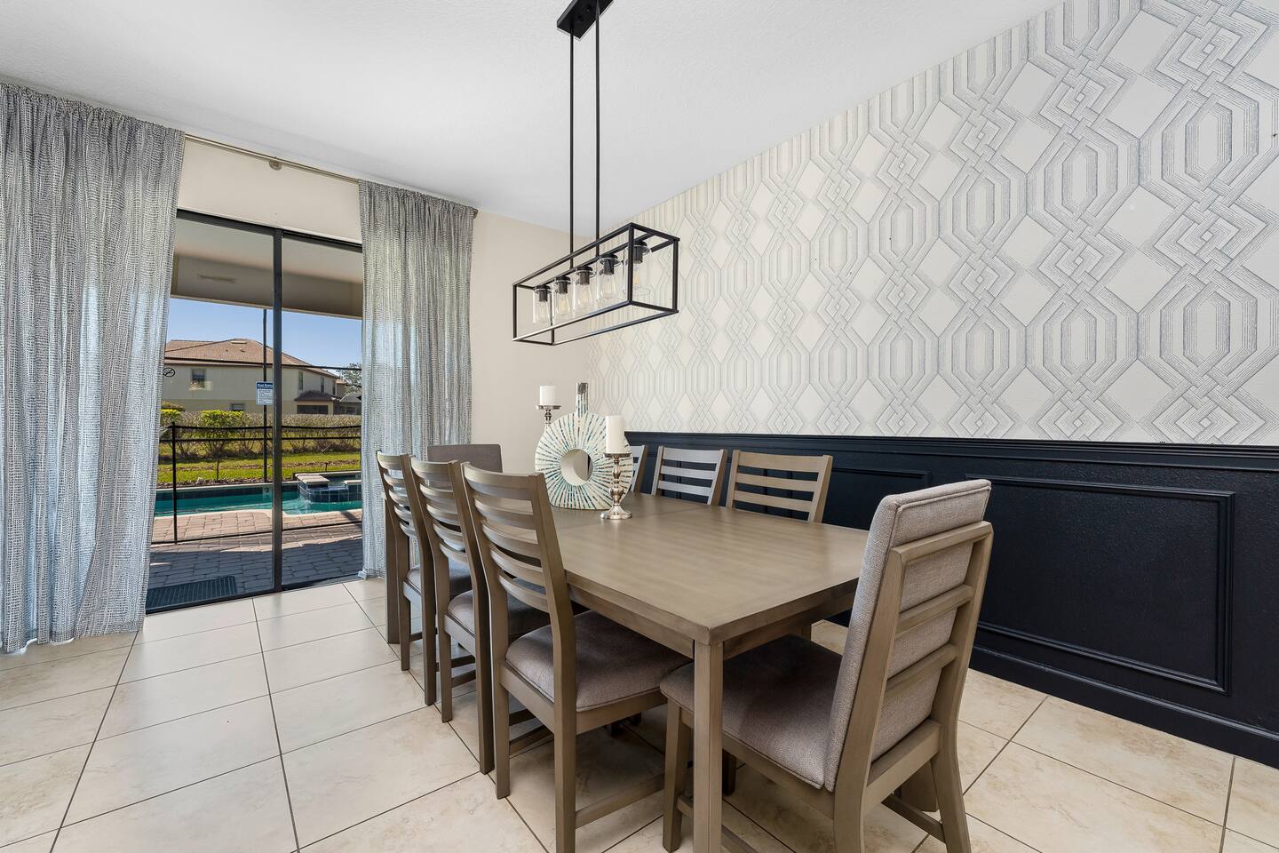 Dining Area: Enjoy meals with a view of the pool in this stylish space designed 
