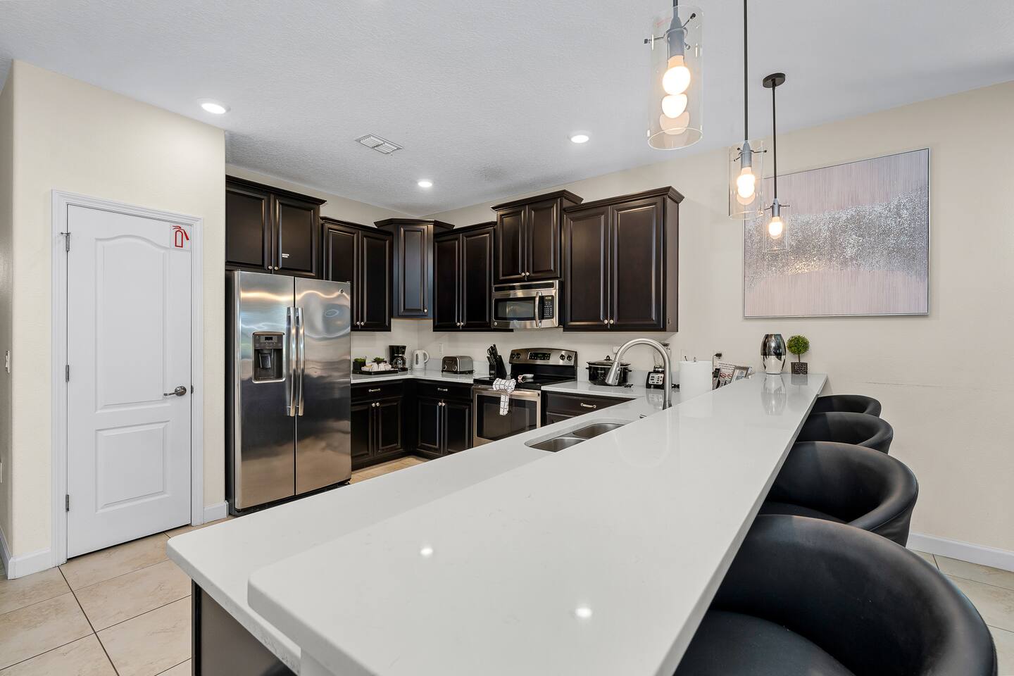 Modern elegance meets functionality in this sleek, well-equipped gourmet kitchen