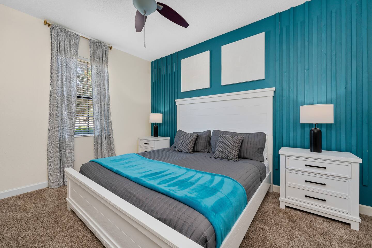 Vibrant teal accent wall and plush bedding create a refreshing retreat!