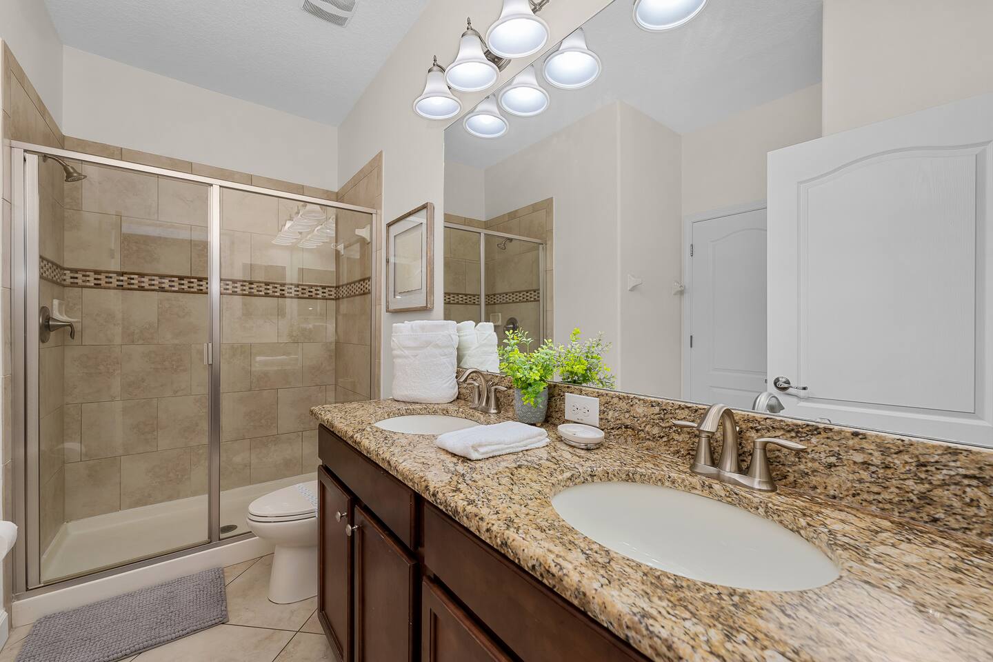 Luxurious granite countertops and spacious shower await your relaxing retreat!