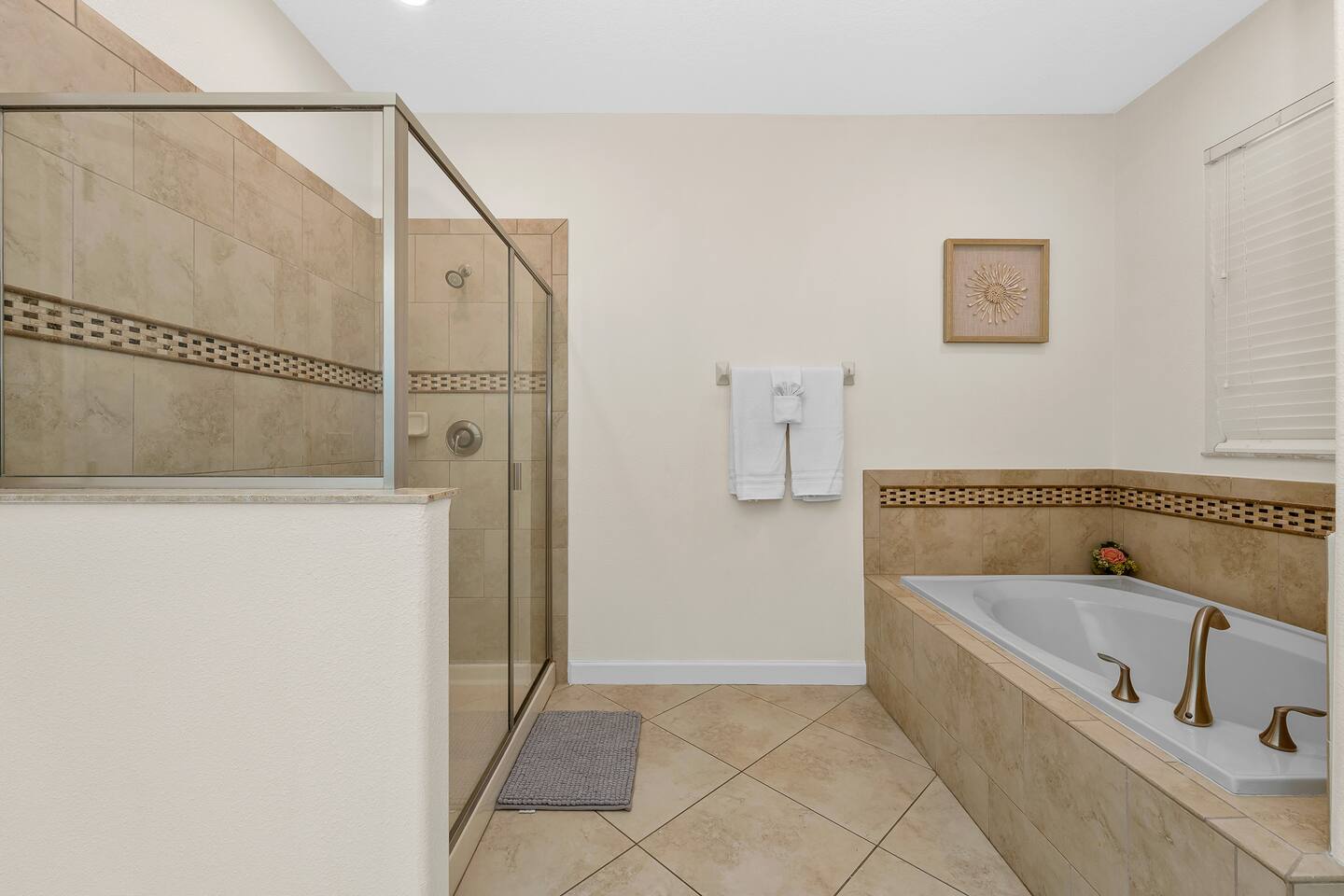 Luxury awaits with a spacious shower and elegant soaking tub for your relaxation