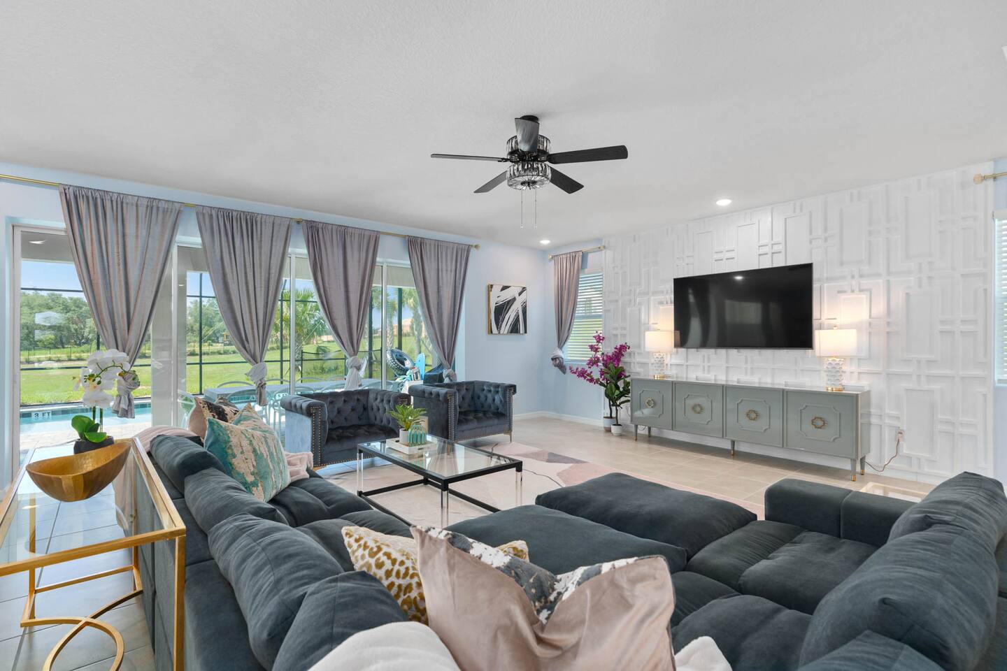 The living room opens directly out to the pool area.
