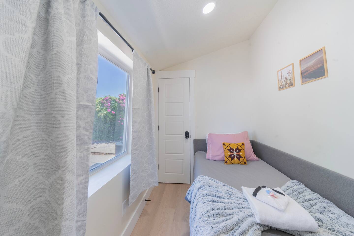 Cozy fourth bedroom with a twin bed and soft throw blankets.
