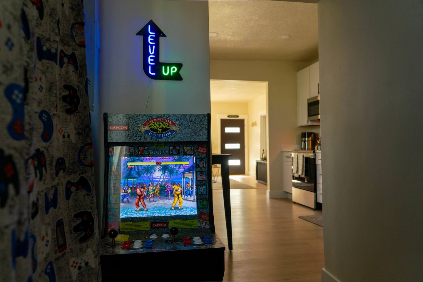 View from the arcade corner down the hallway toward the kitchen and front door.