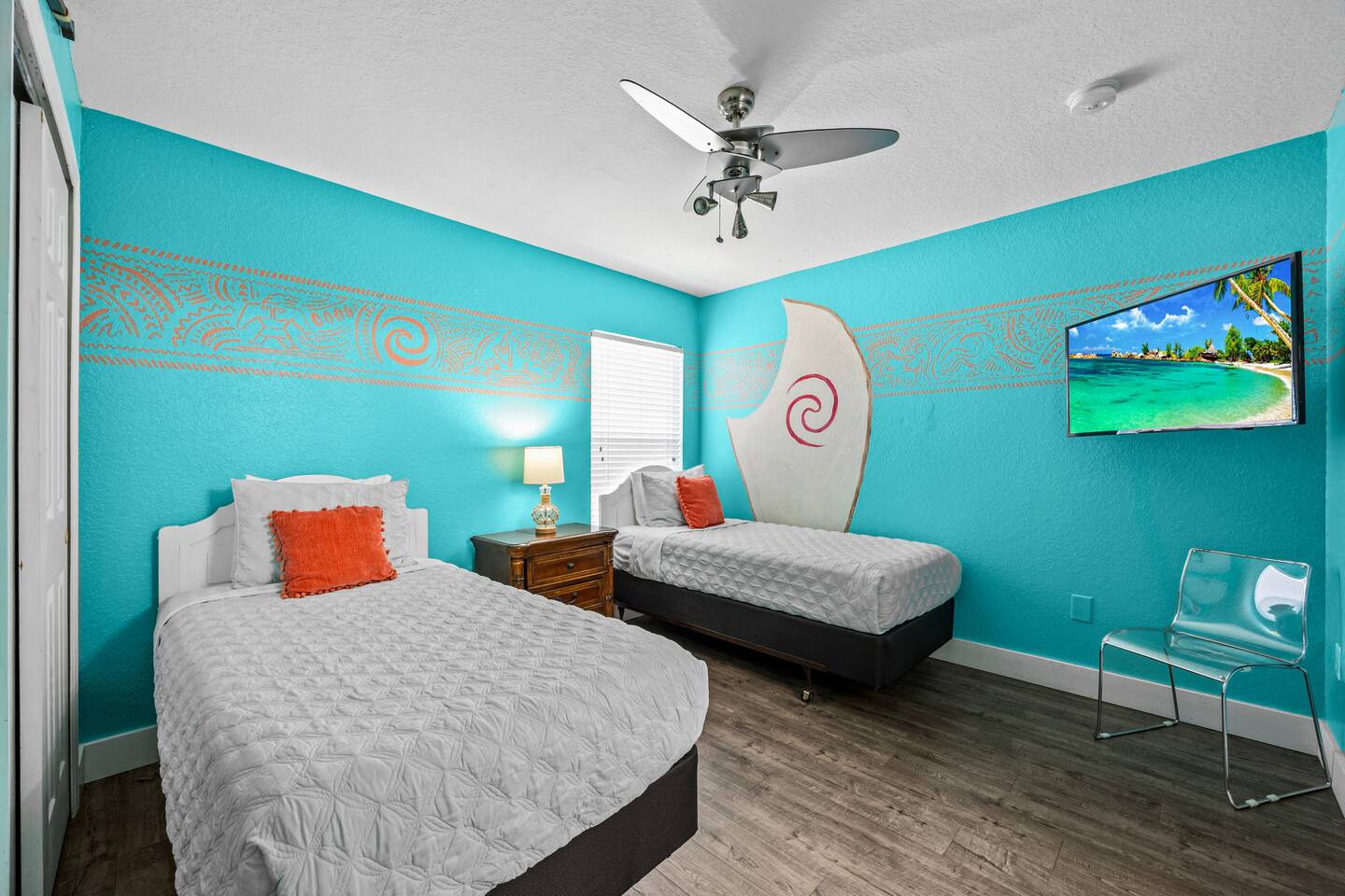 Moana-themed bedroom with two twin beds, teal walls, a sail headboard, and wall-