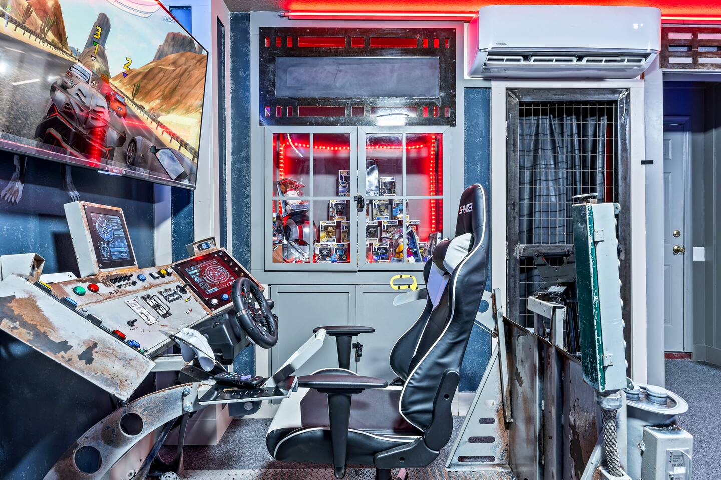 Racing simulator with a bucket seat, dual screens, and a detailed control consol